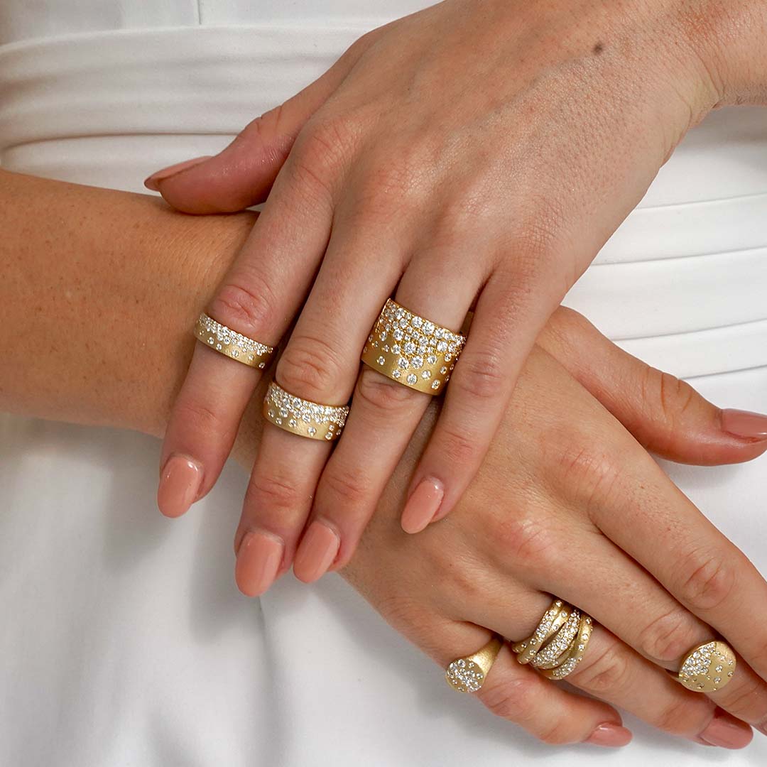 Woman Wearing Yellow Gold and Diamond Rings