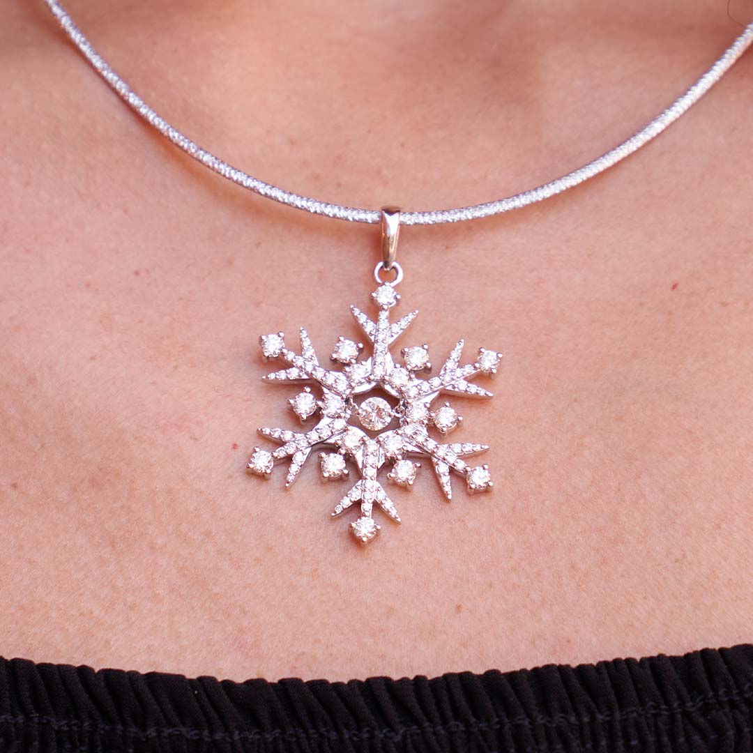Woman Wearing White Gold and Diamond Snowflake Pendant