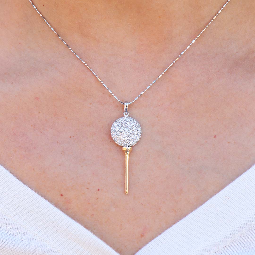 Woman Wearing Diamond Golf Ball Pendant with Yellow Gold Tee by Park City Jewelers