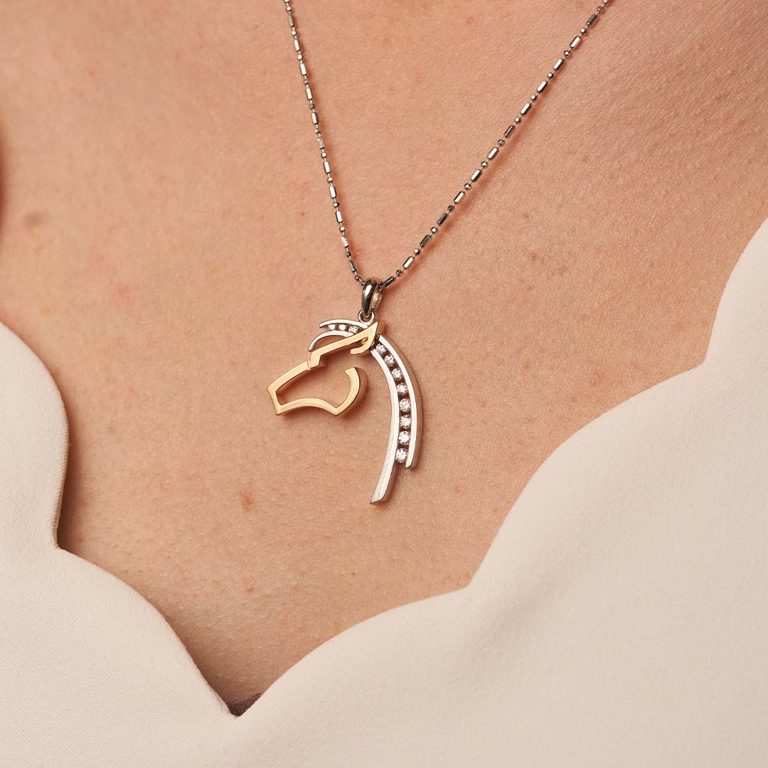 Woman Wearing a Two Toned White and Yellow Gold Horse Pendant with Diamond Mane