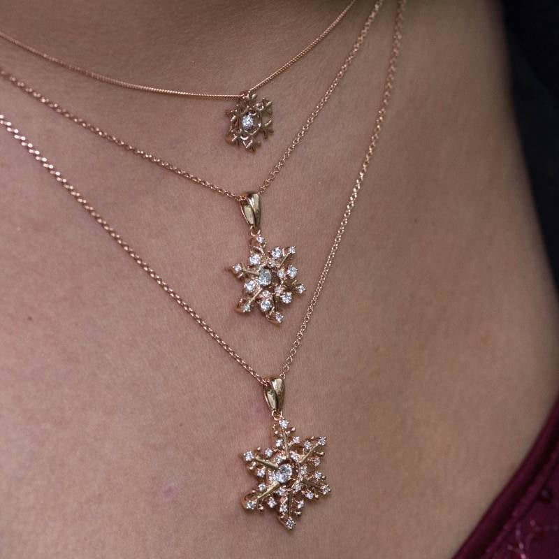 3 snowflake pendants on different length chains - Park City Jewelers.