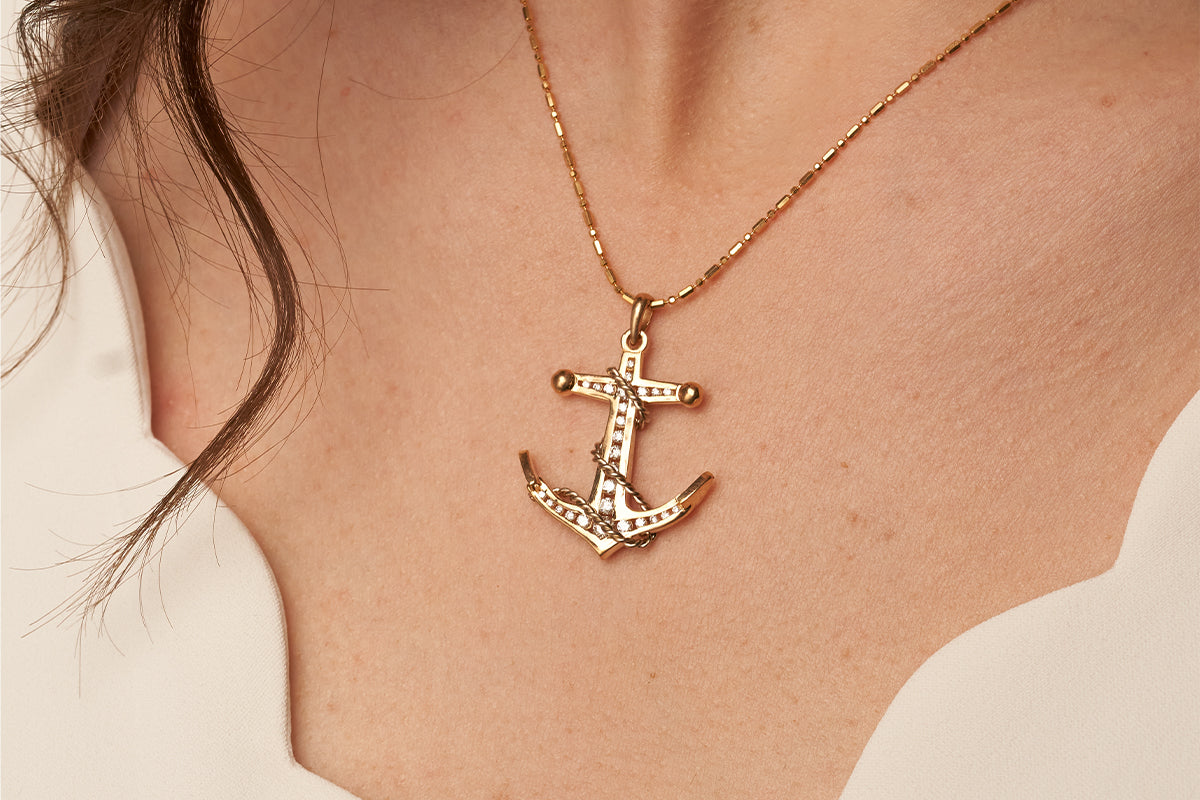 Woman Wearing Two-Toned 14K White and Yellow Gold Anchor Pendant from Park City Jewelers