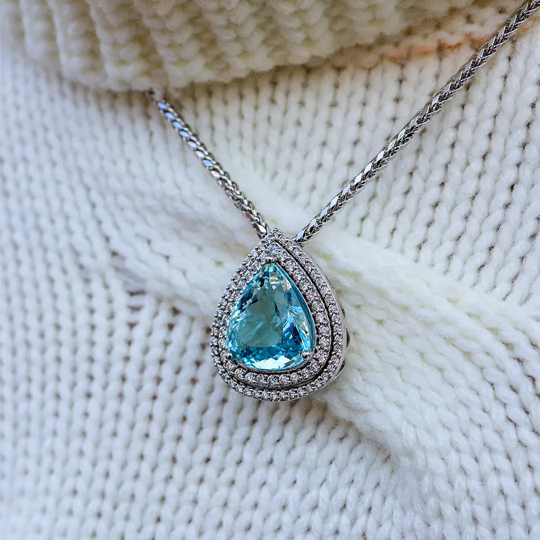 Woman Wearing an Aquamarine Pendant from Park City Jewelers.