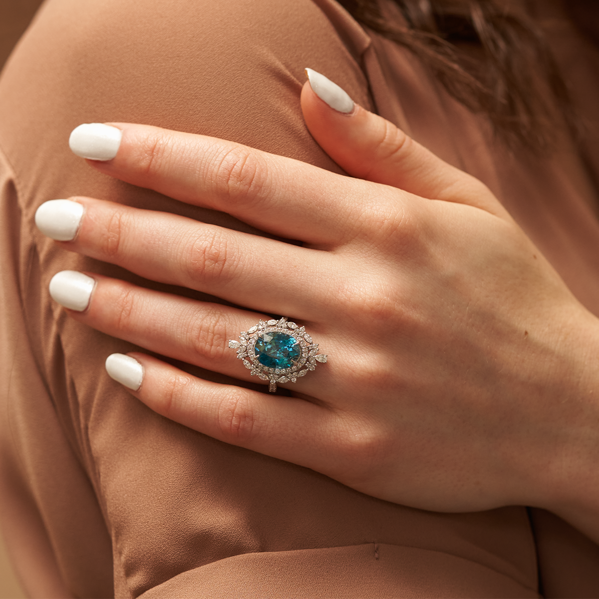 Woman Wearing a Blue Zircon Ring with Double Diamond Halo - Park City Jewelers