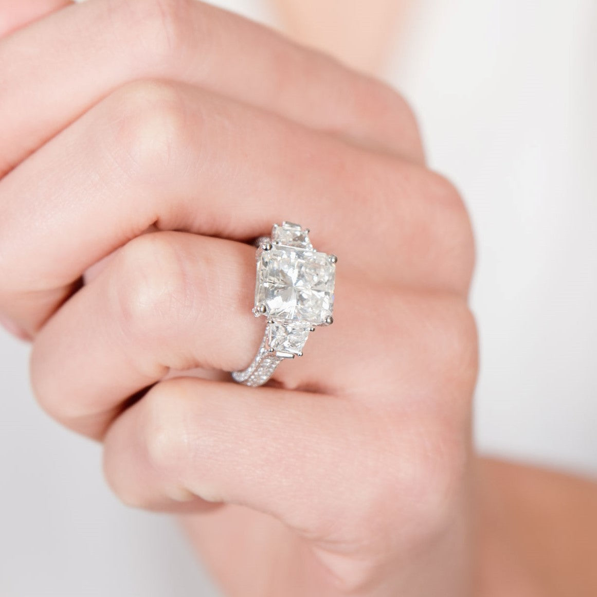 Woman wearing large princess cut diamond ring