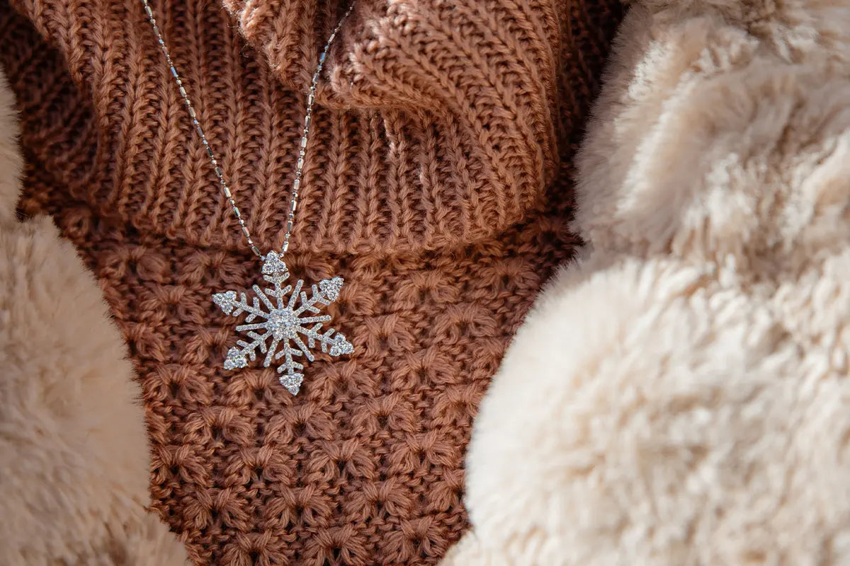 Woman Wearing White Gold and Diamond Snowflake Pendant from Park City Jewelers