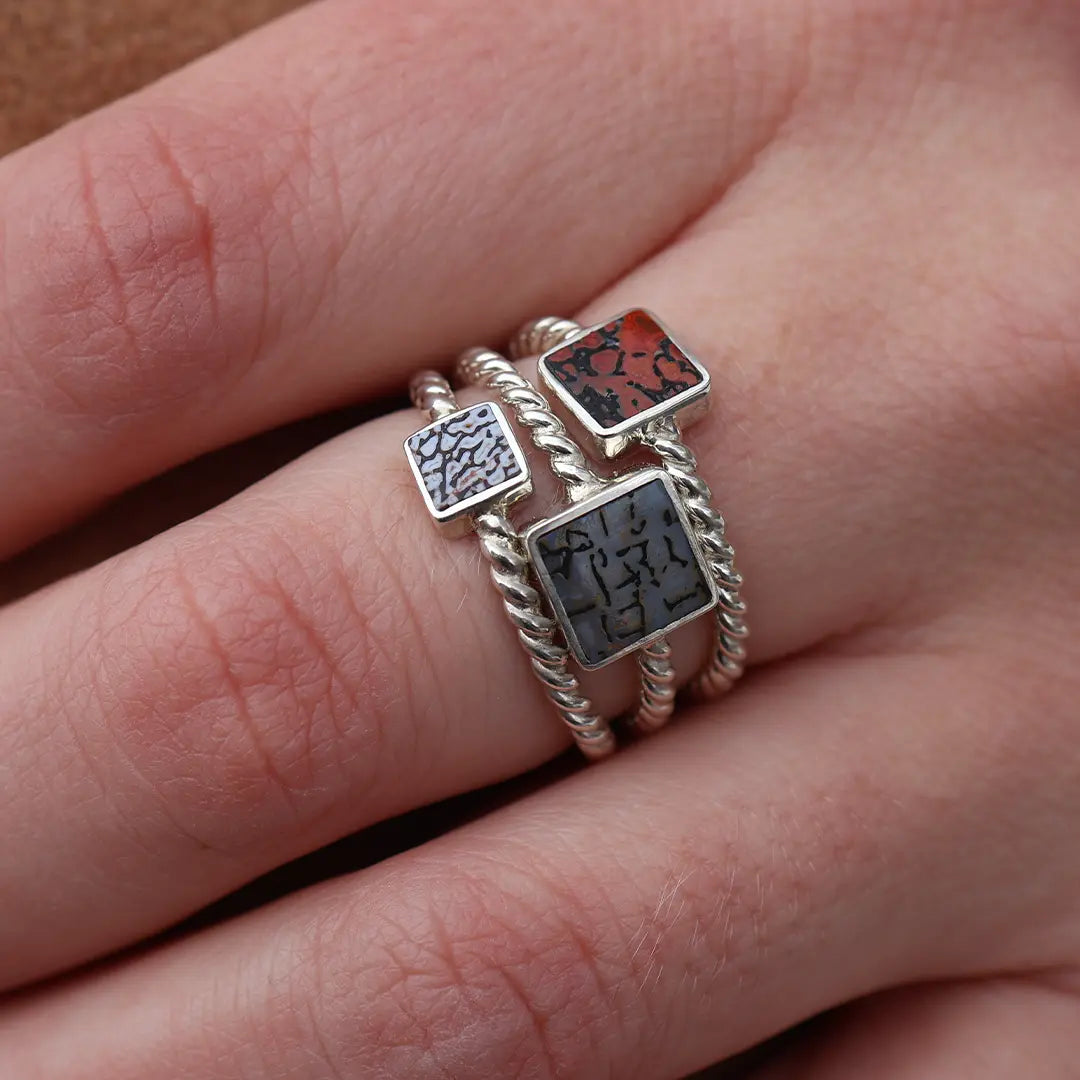 Woman Wearing Three Stone Dinosaur Bone Inlay Ring - Park City Jewelers
