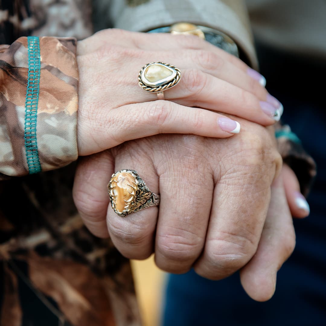 Man and Woman Eech Wearing an Elk Ivory Ring - Park City Jewelers