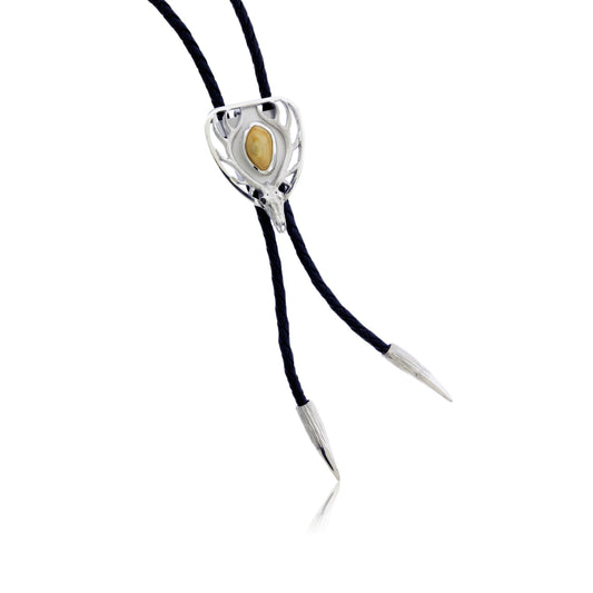 The custom elk ivory version of the sculptural bolo tie, shown with a polished elk ivory set in the center to display the customization option.