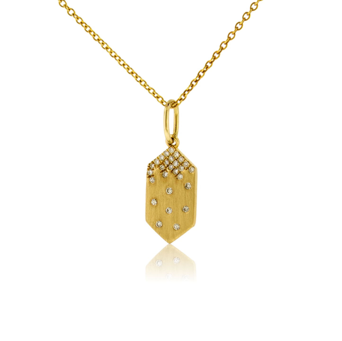 A 14K yellow gold geometric tag-shaped pendant with a satin finish, featuring a cluster of pave diamonds at the top and scattered flush-set diamonds below, shown on a gold chain.