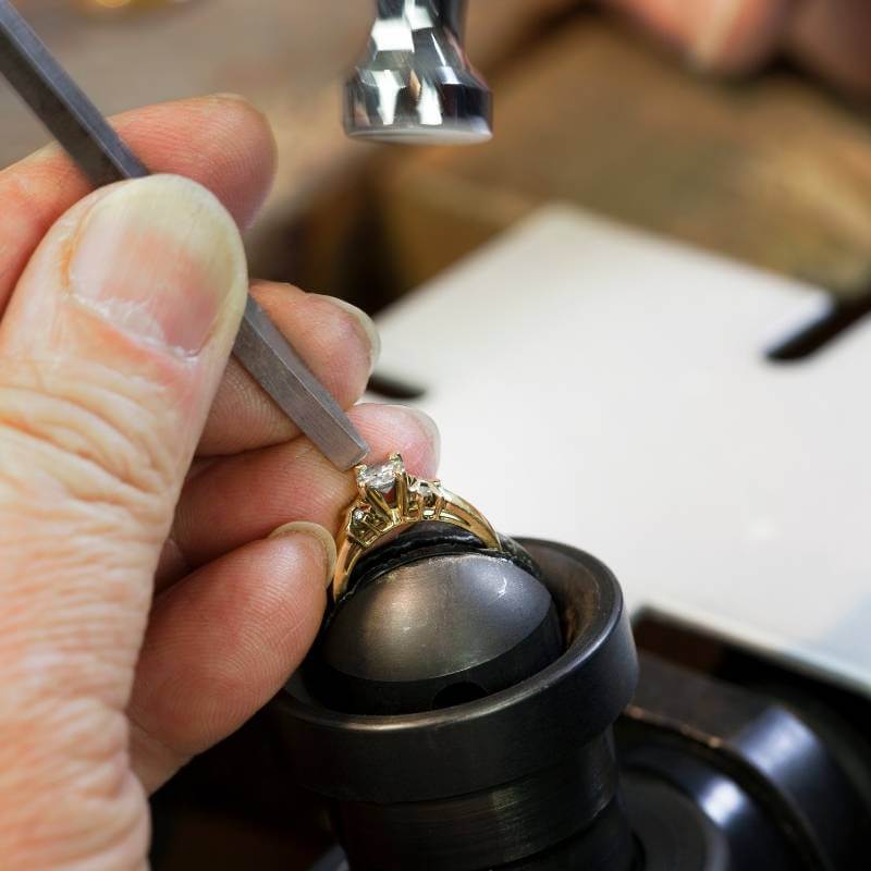 Jeweler repairing diamond ring