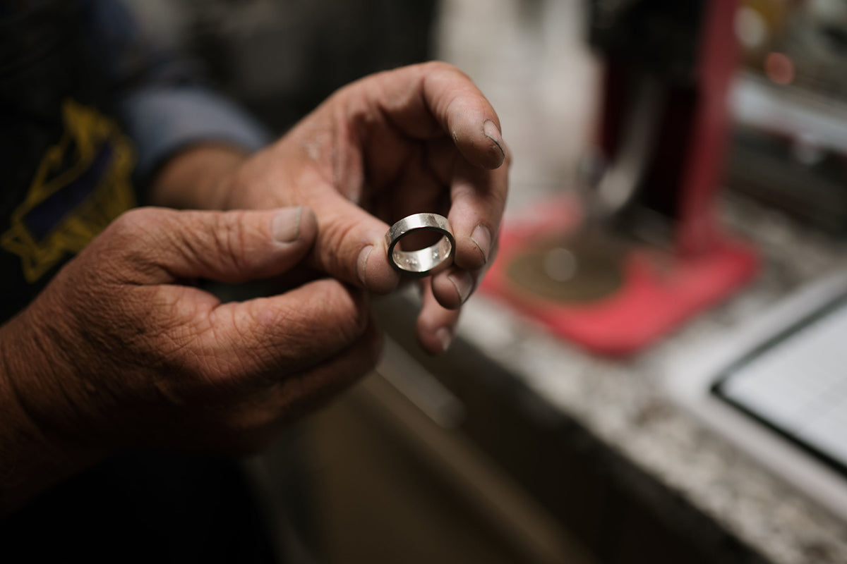Man Holding Ring in Jewelry Shop
