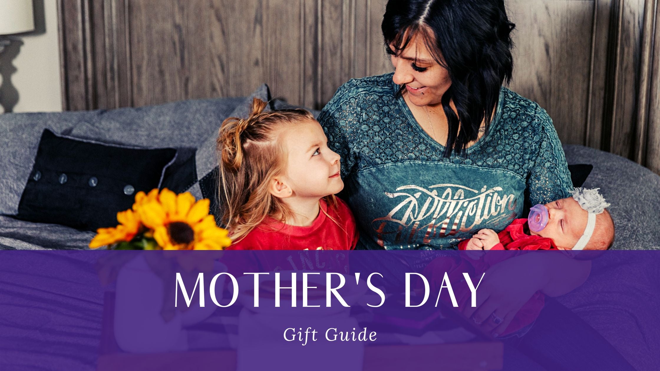 Mother's Day Gift Guide Blog Banner with a Mom holding a baby with her arm around her daughter.