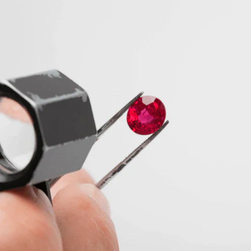 Looking at a Red Gemstone Through a Loop.