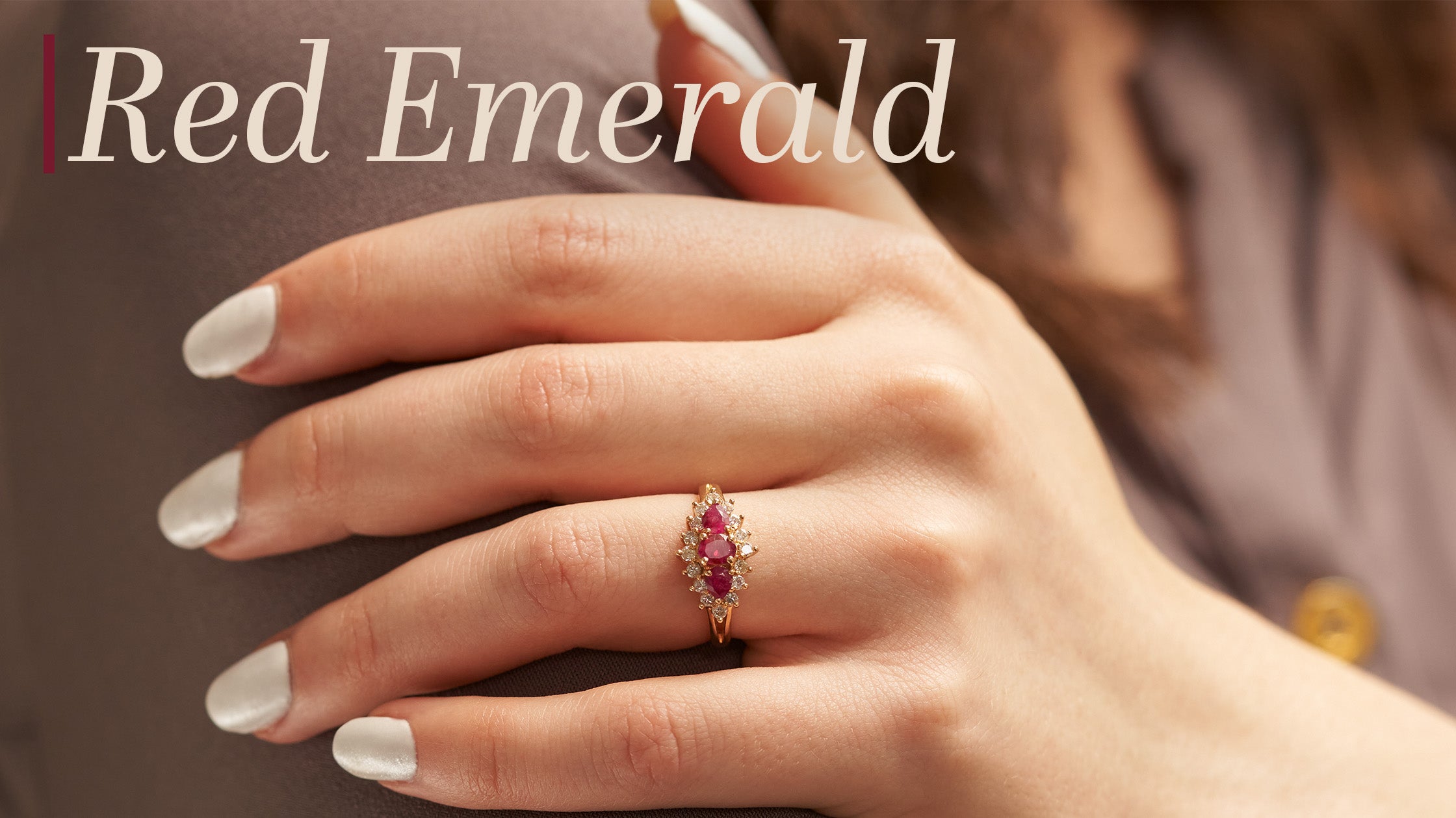 Red Emerald Blog Banner with Woman Wearing a Three Stone Red Emerald Ring from Park City Jewelers.