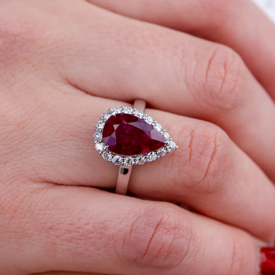 Women Wearing a Red Emerald with Diamond Halo Ring - Park City Jewelers