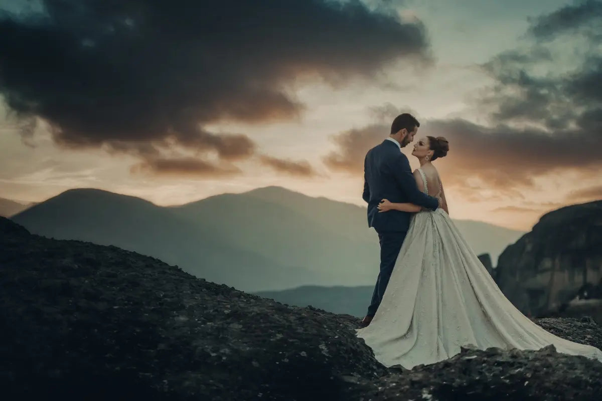 Bride and Groom embracing with a mountain landscape in the background