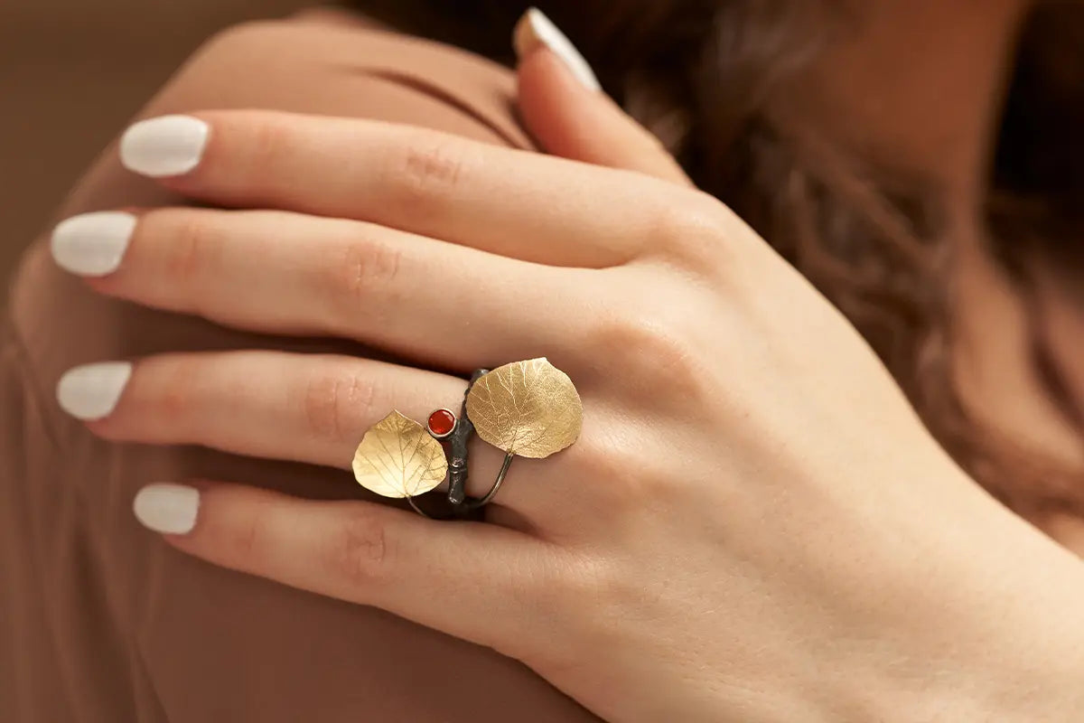 Woman Wearing Wolfgang Vaatz Aspen Inspired Ring with Gold Leaves from Park City Jewelers