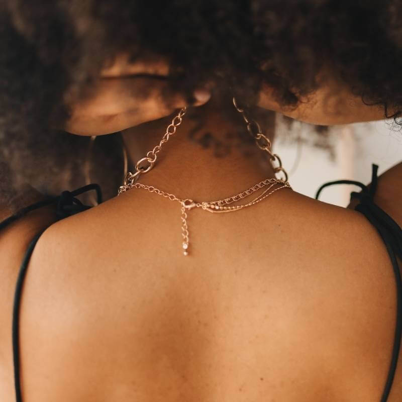 Woman putting on jewelry chain
