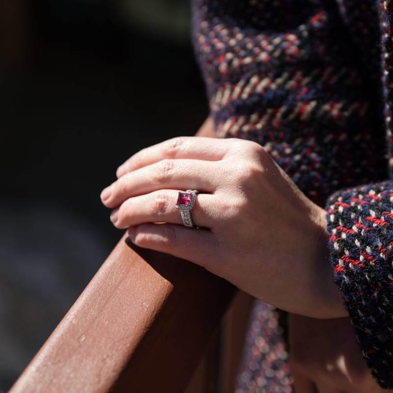 Woman wearing red emerald ring