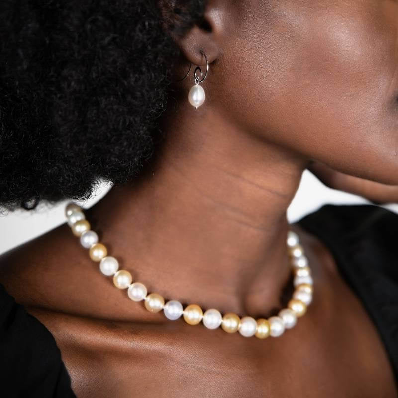 Woman wearing pearl earrings and pearl necklace