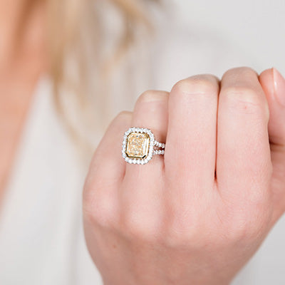 Woman wearing yellow diamond engagement ring