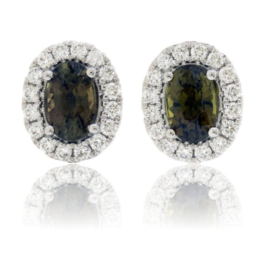A pair of oval halo stud earrings in 14K white gold, featuring brownish-green alexandrite center stones surrounded by brilliant diamonds.