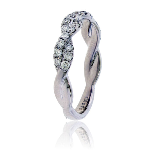 Standing view of a criss-cross diamond ring, highlighting the elegant twisted silhouette and the sparkle of the pavé-set band.