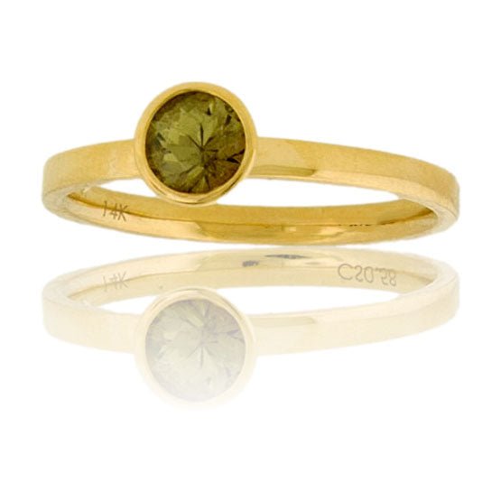 A 14K yellow gold solitaire ring with a satin finish, featuring a round, olive-green alexandrite in a modern bezel setting.