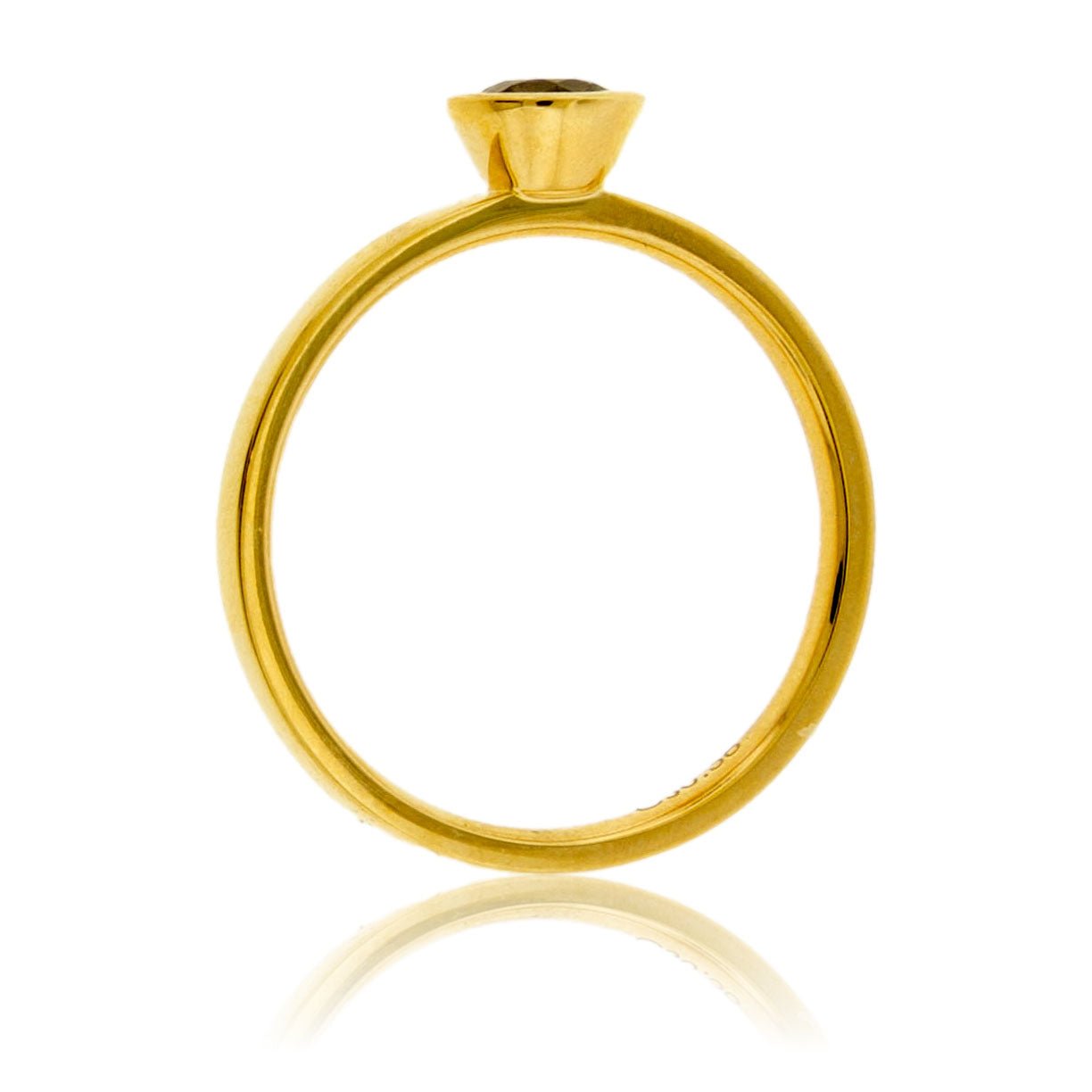 Side profile of a bezel-set alexandrite solitaire ring, showing the clean lines of the 14K yellow gold setting and band.