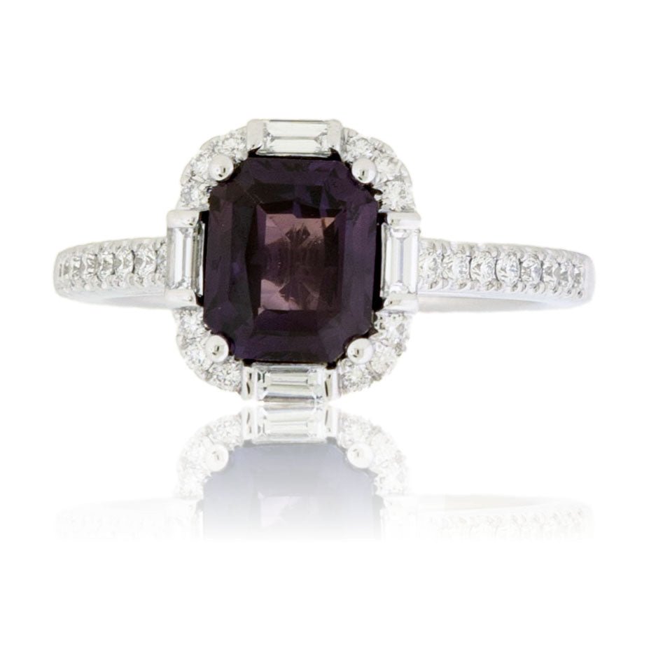 Top-down view of an Art Deco style engagement ring, featuring a large, radiant-cut purple sapphire surrounded by a halo of round and baguette diamonds.
