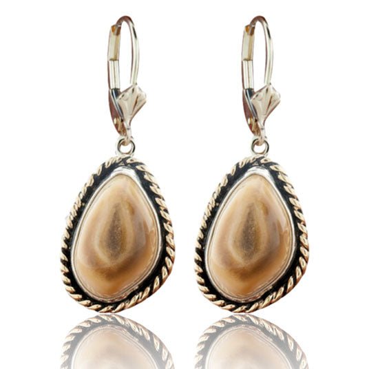 A pair of two-tone dangle earrings featuring polished elk ivories, each framed with a braided 14K yellow gold halo in a sterling silver setting.