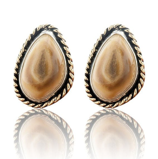 A pair of two-tone stud earrings featuring polished elk ivories, each framed with a braided 14K yellow gold halo and a darkened sterling silver bezel.