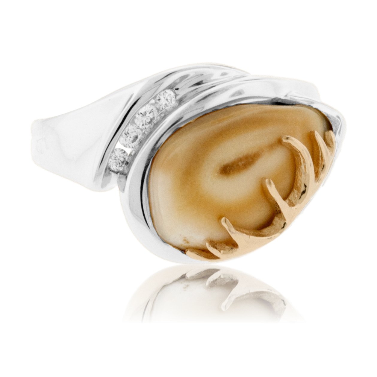 A two-tone elk ivory ring with a white gold band, a yellow gold antler accent, and a channel of four diamonds.