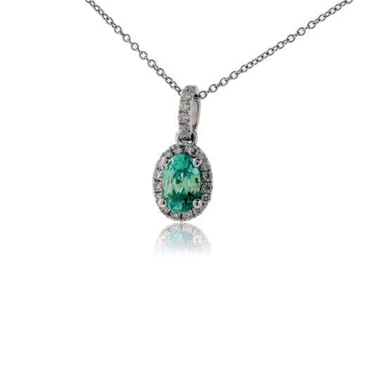 Simple Oval Blue Zircon in Diamond Halo Pendant - Park City Jewelers