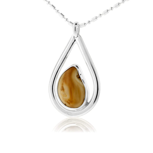 A modern teardrop pendant in sterling silver, with a custom-fit elk ivory floating in a bezel setting in the center.