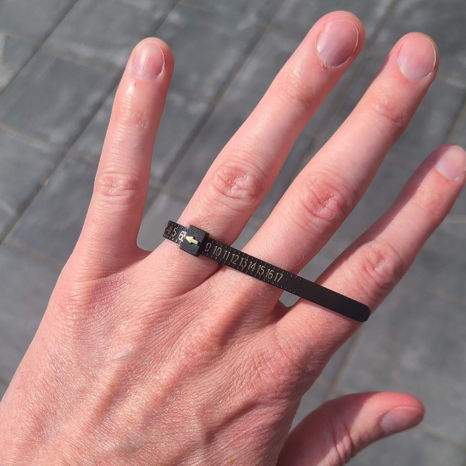 Finger with a Ring Sizer on it - Park City Jewelers. 