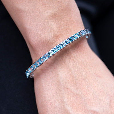 Woman wearing blue topaz gradient Bellarri bracelet 