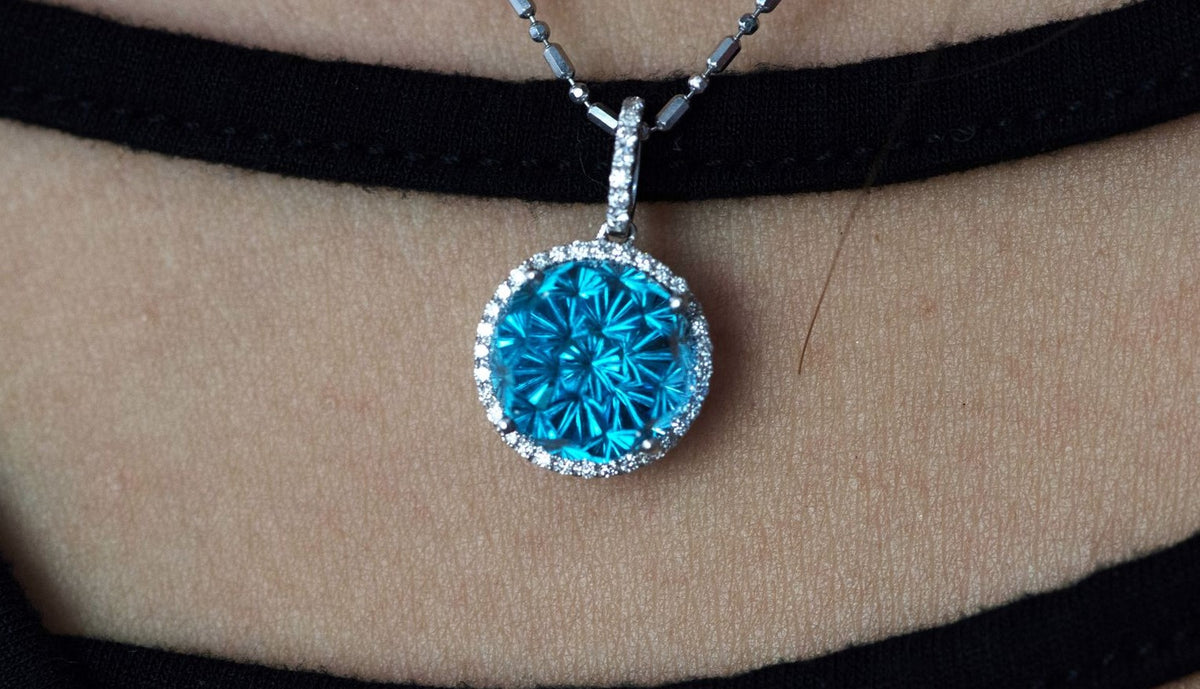 Woman wearing blue topaz necklace