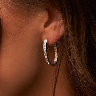 Woman Wearing Gold Confetti Hoop Earrings by Park City Jewelers