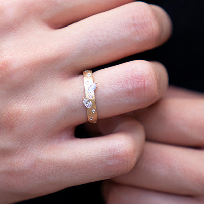Woman wearing gold and diamond confetti ring