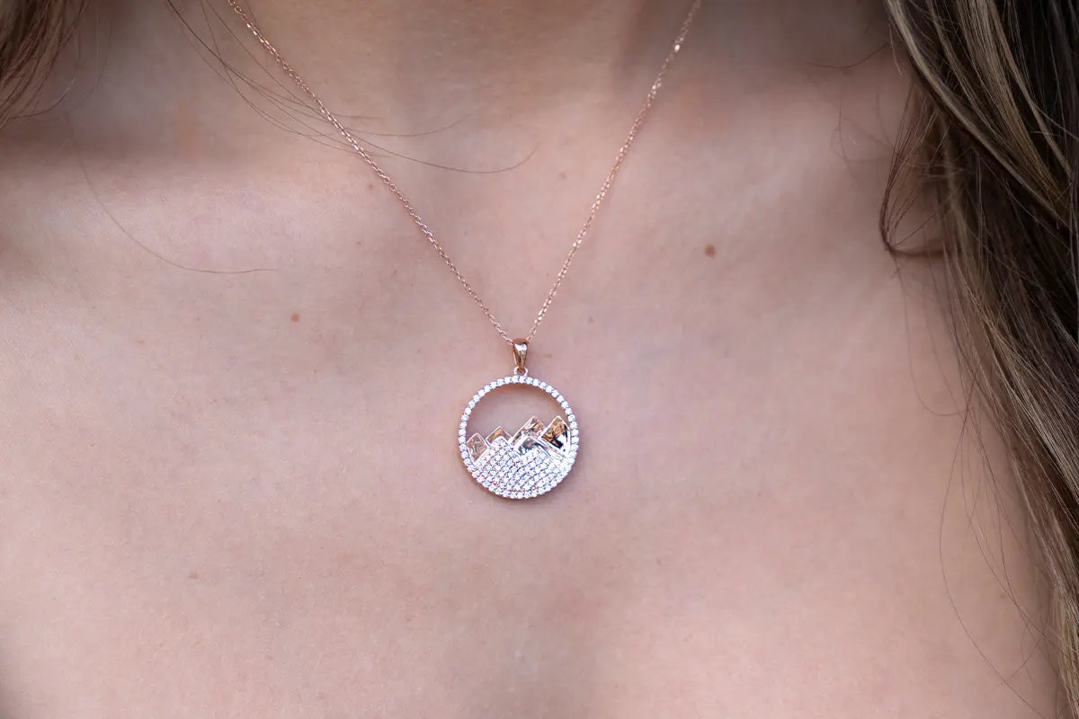 Woman Wearing a Diamond Circle Mountain Pendant from Park City Jewelers