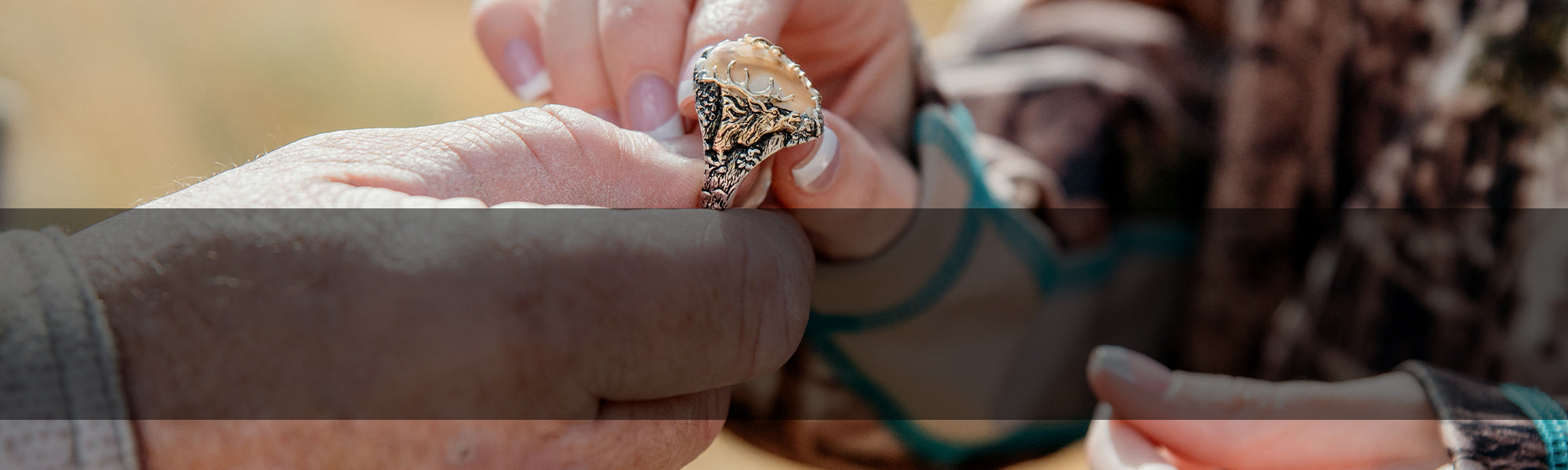 Man Handing Elk Ivory Ring from Park City Jewelers to a Woman