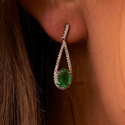 Woman Wearing Emerald Earrings by Park City Jewelers