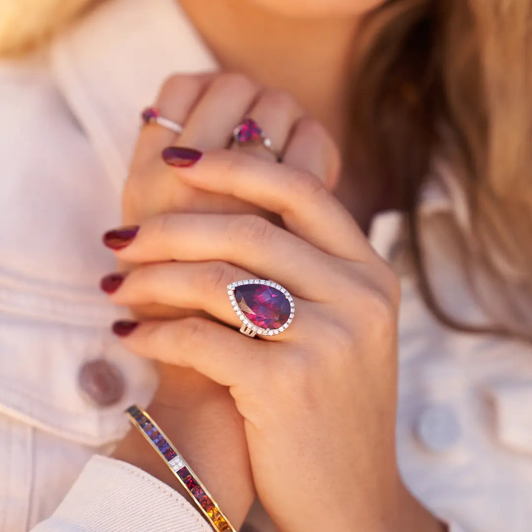 Woman Wearing Pear Shaped Rhodolite Garnet Ring from Park City Jewelers. 