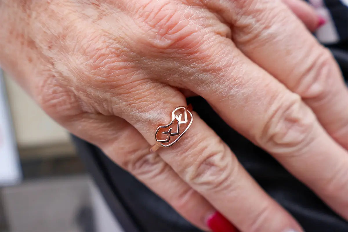 Woman Wearing a Rose Gold Mountain Goggle Ring from Park City Jewelers.