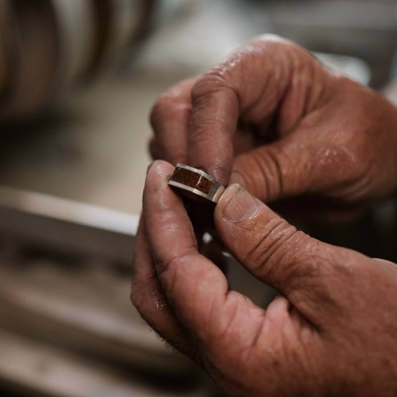 Jeweler holding dinosaur bone ring