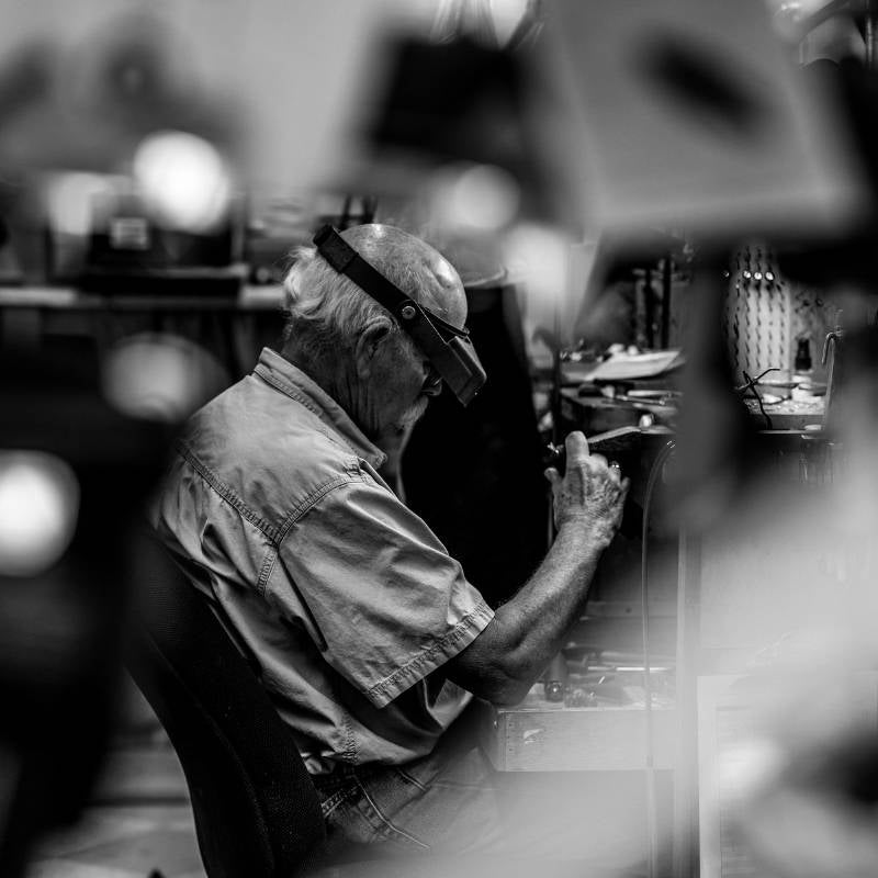 Jeweler working at jewelers bench