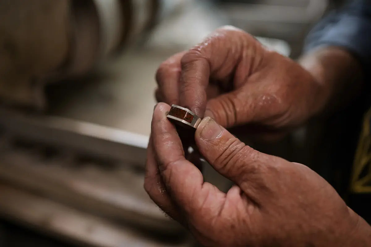 Jeweler Holding a Custom Dinosaur Bone Ring by Park City Jewelers