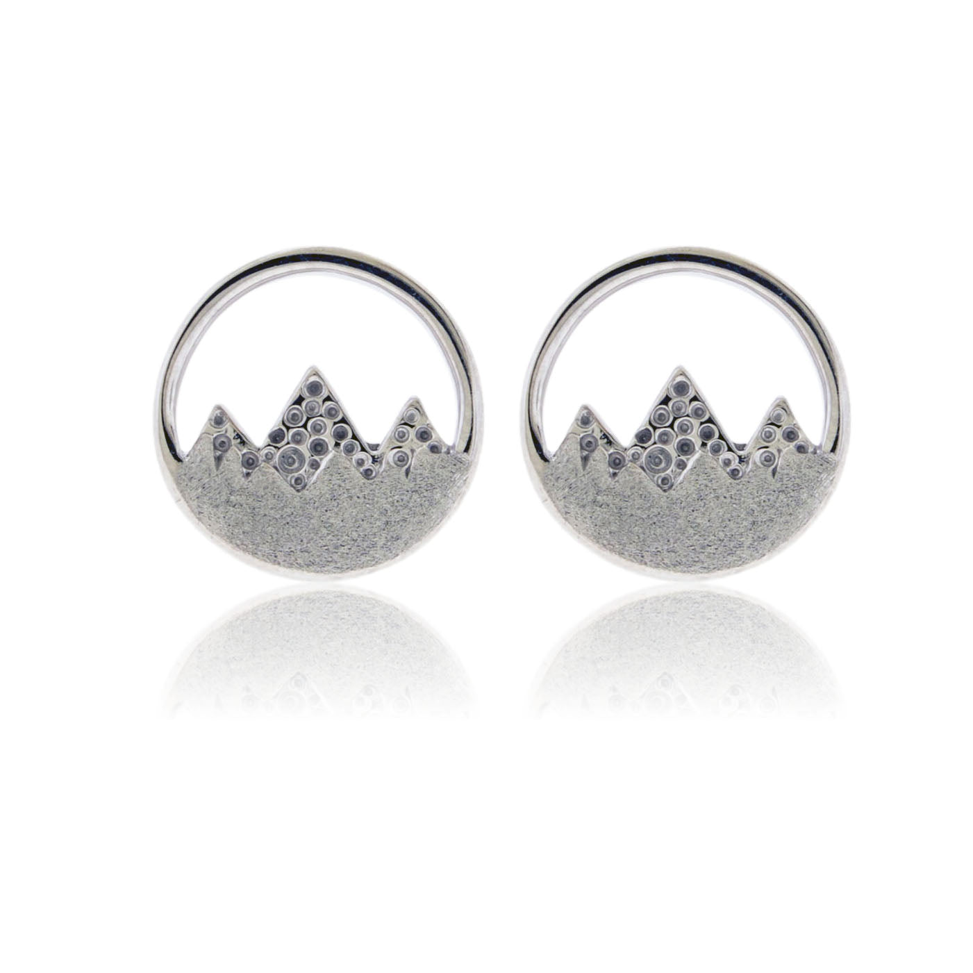 Silver earrings with mountain design on a white background